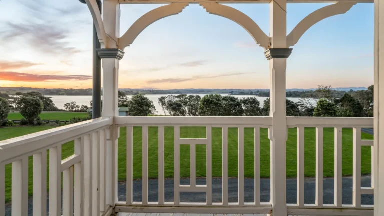 Verandah view of the harbour at dusk, The Huntly House, Clarks Beach